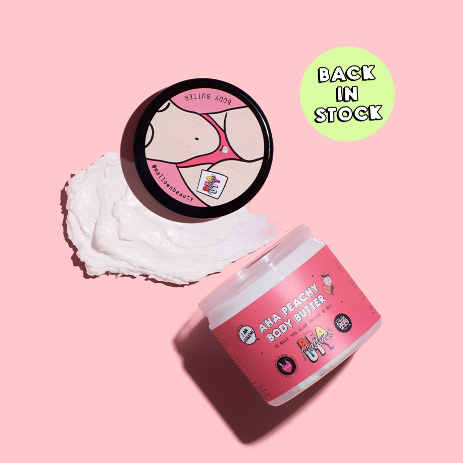 A container of AHA Peachy Body Butter with its lid removed, showing the product inside. There is also a graphic indicating 'BACK IN STOCK'.