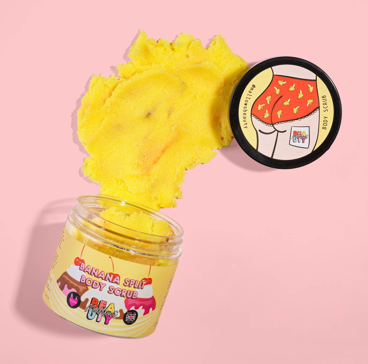Banana split themed body scrub with a yellow scrub texture on a pink background
