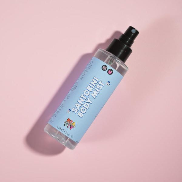 Santorini mist in a bottle on a pink background