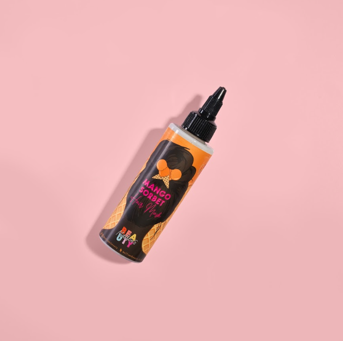Mango sorbet hair mask in a bottle on a pink background